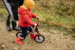 a kid doing balance bike