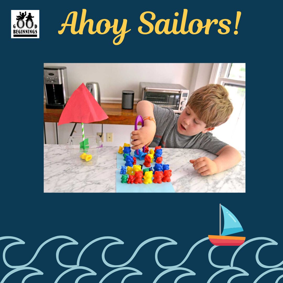 Activity 4 (2) Graphic with the text "Ahoy Sailors!" in yellow. The center photo shows a young boy practicing fine motor skills by using purple tongs to pick up small, colorful plastic bears and place them into a homemade boat. The boat is crafted from a clear plastic tub, a striped straw mast, and a red paper sail. The dark blue background features the Good Beginnings logo at the top left and illustrated ocean waves with a small sailboat at the bottom.